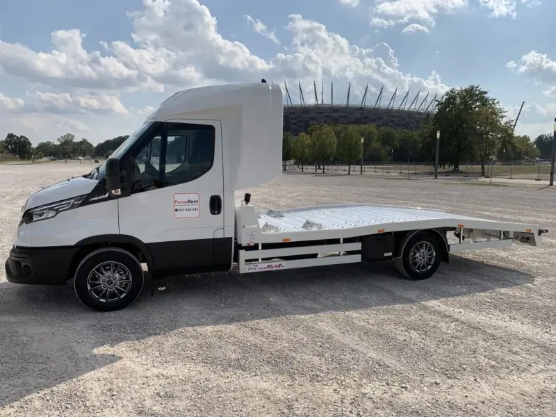 Laweta Iveco Daily zaparkowana bokiem, widoczna cała platforma
